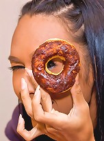 Frisky ladyboy tasting donuts before a strip-show